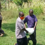 Wir verteilen Essen an unsere Familien – PMCO Uganda e.V.